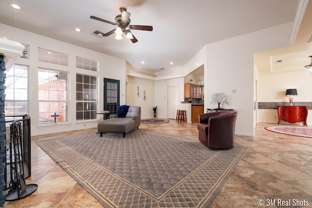 living room featuring stone finish flooring, recessed lighting, baseboards, and ceiling fan