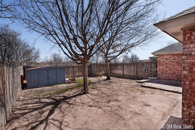 view of yard with an outbuilding, a storage unit, and a fenced backyard