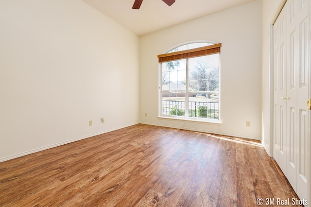 unfurnished room featuring wood finished floors, baseboards, and ceiling fan