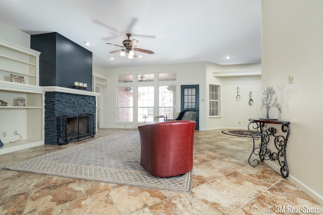 living area featuring recessed lighting, ceiling fan, a fireplace, and baseboards