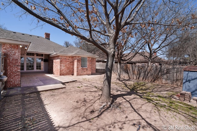 view of yard featuring a patio and fence