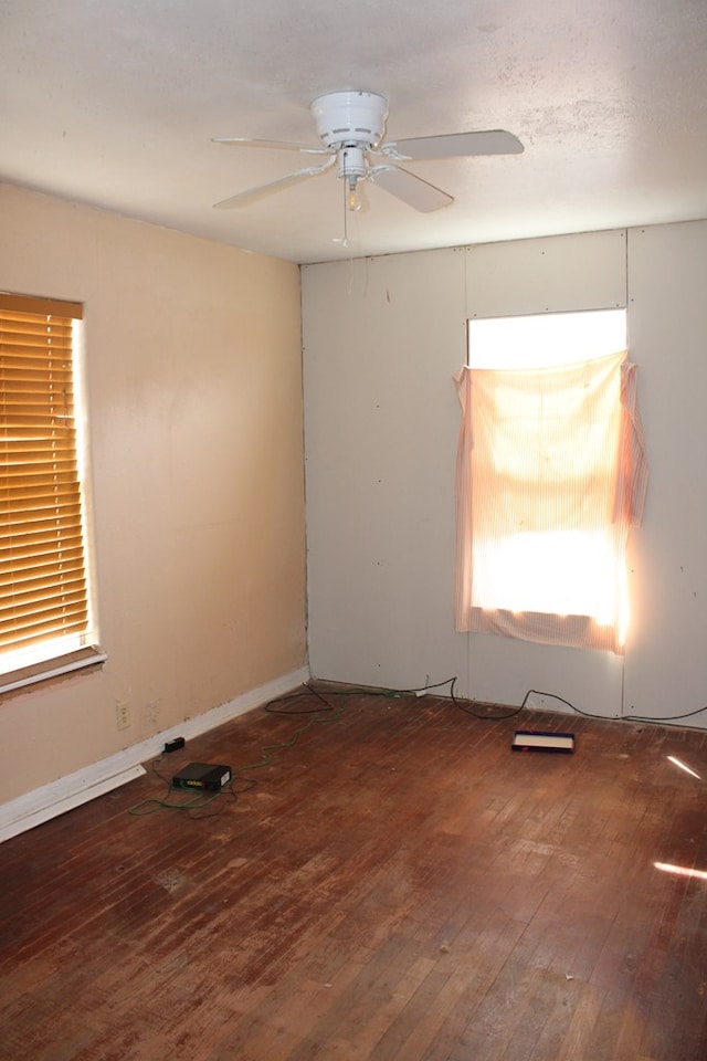 empty room with ceiling fan and hardwood / wood-style floors