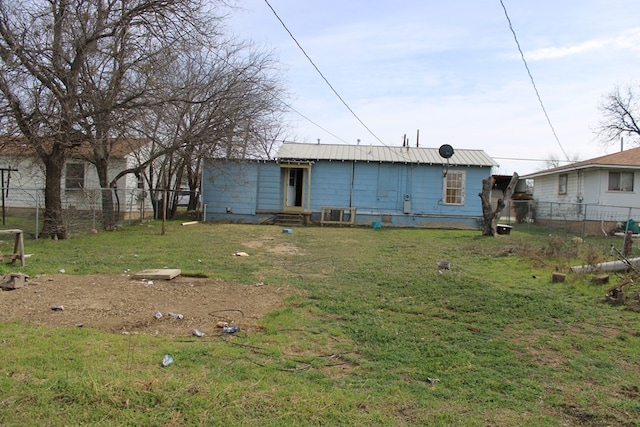 back of property featuring a lawn