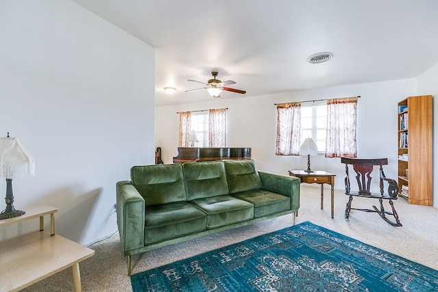 carpeted living room featuring a ceiling fan and visible vents