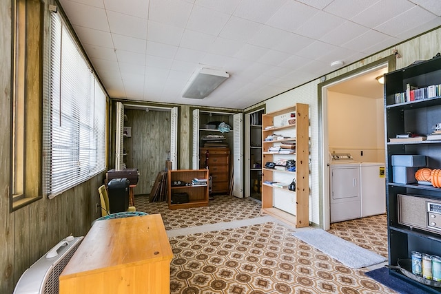 interior space featuring wood walls and washer and dryer