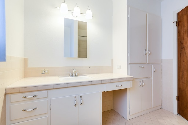 bathroom with tile patterned flooring and vanity