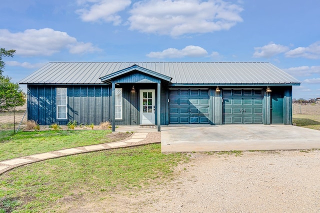 view of front of house with a garage and a front lawn