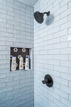 bathroom with tiled shower