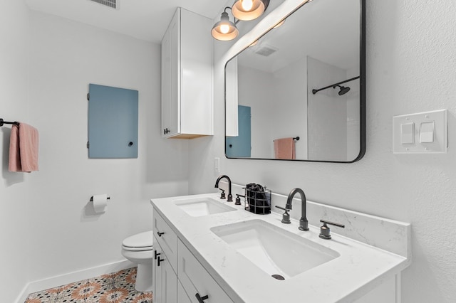 bathroom with vanity, a shower, and toilet