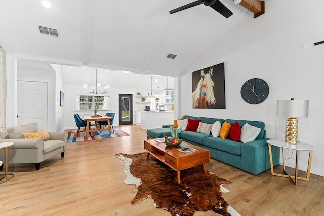 living room featuring ceiling fan with notable chandelier, high vaulted ceiling, beam ceiling, and light hardwood / wood-style floors