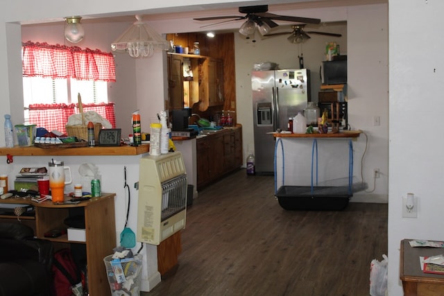 kitchen featuring stainless steel refrigerator with ice dispenser, heating unit, ceiling fan, and dark hardwood / wood-style flooring