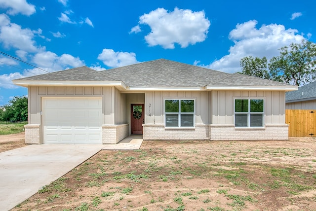 2114 Deaton St, San Angelo, TX 76903 - ranch-style home with a shingled roof, a garage, and brick siding