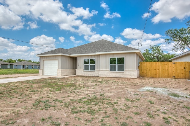 2114 Deaton St, San Angelo, TX 76903 - view of front of house with brick siding, a garage, concrete driveway, and roof with shingles