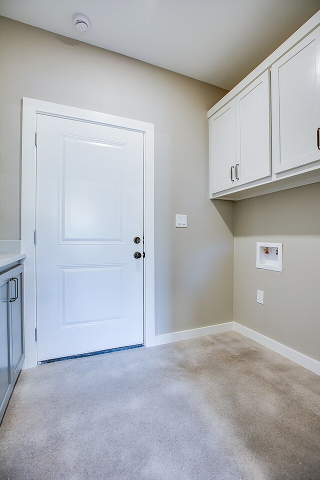 2114 Deaton St, San Angelo, TX 76903 - laundry room featuring hookup for a washing machine, cabinet space, baseboards, and light colored carpet