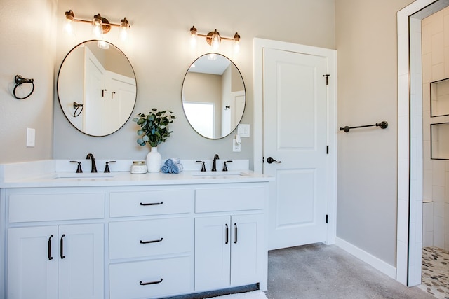 2114 Deaton St, San Angelo, TX 76903 - bathroom with double vanity, baseboards, concrete floors, and tiled shower