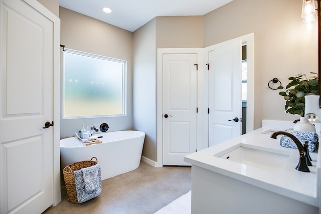 2114 Deaton St, San Angelo, TX 76903 - full bathroom featuring a freestanding bath, healthy amount of natural light, vanity, and recessed lighting