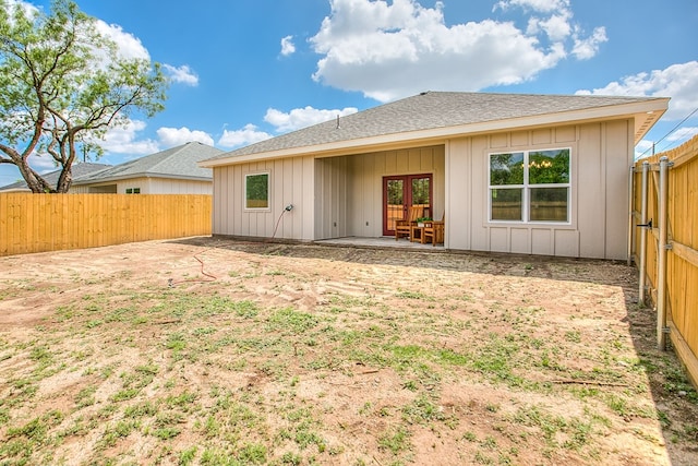2114 Deaton St, San Angelo, TX 76903 - rear view of house featuring french doors, board and batten siding, roof with shingles, a fenced backyard, and a patio