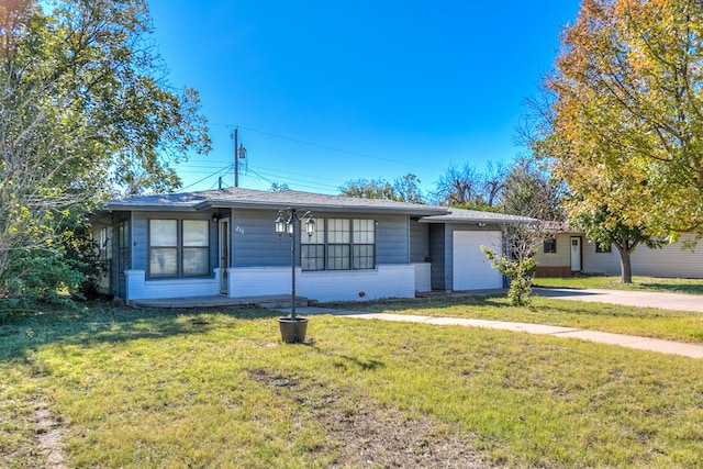 ranch-style home with a garage and a front lawn