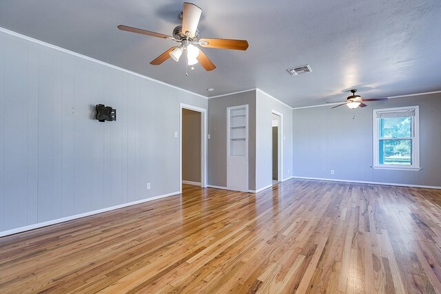 spare room with ceiling fan, light hardwood / wood-style flooring, ornamental molding, and a textured ceiling