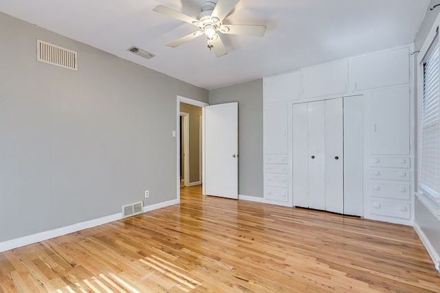 unfurnished bedroom with ceiling fan, a closet, and light wood-type flooring