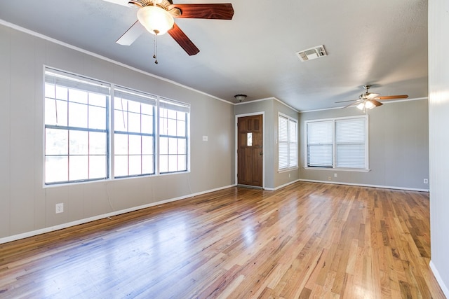 unfurnished living room featuring ornamental molding, light hardwood / wood-style floors, and ceiling fan