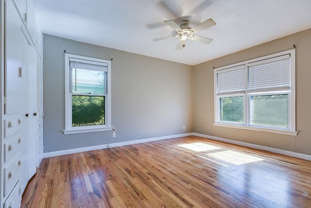 unfurnished room with ceiling fan, plenty of natural light, and light wood-type flooring