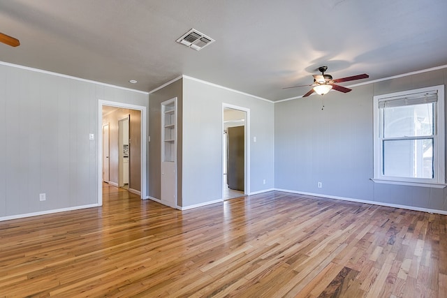 empty room with crown molding, ceiling fan, and light wood-type flooring