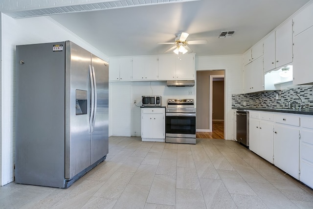 kitchen featuring stainless steel appliances, sink, and white cabinets