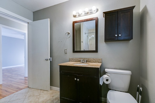 bathroom featuring vanity, tile patterned floors, and toilet