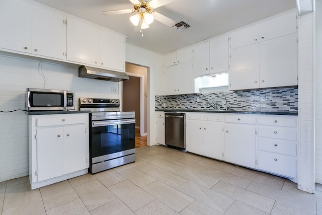 kitchen featuring white cabinetry, stainless steel appliances, and range hood