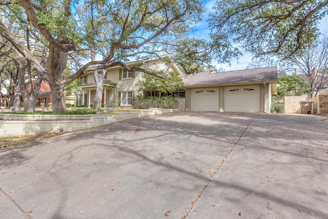 traditional home featuring aphalt driveway