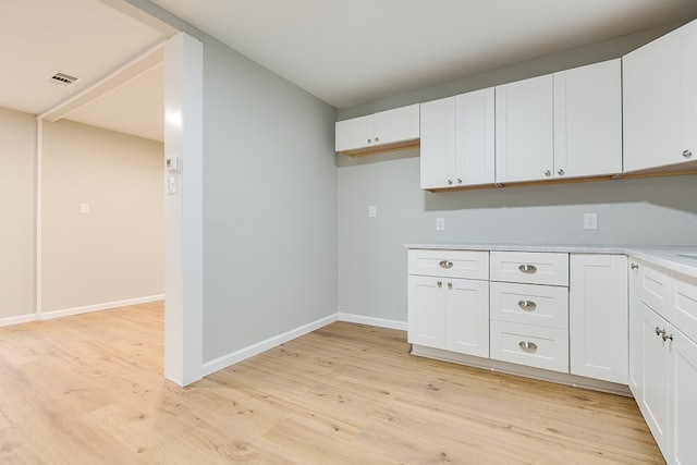 laundry room with light wood-type flooring