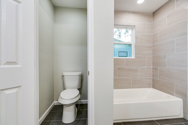 bathroom featuring tile patterned floors, toilet, and shower / bathing tub combination