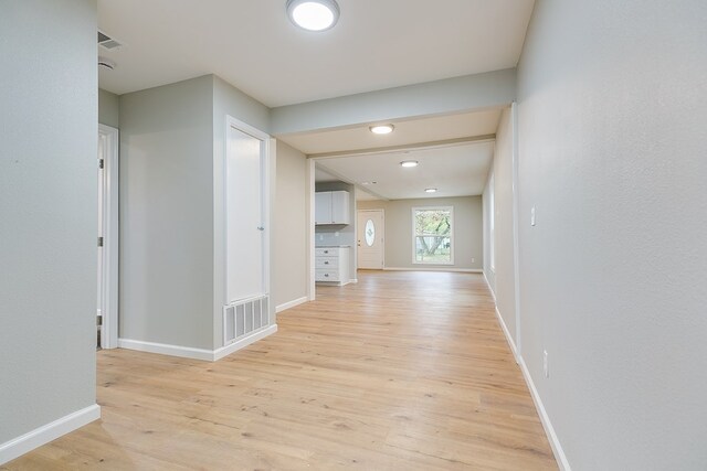 206 N Montague Ave, San Angelo, TX 76905 - hallway with baseboards, visible vents, and light wood-type flooring