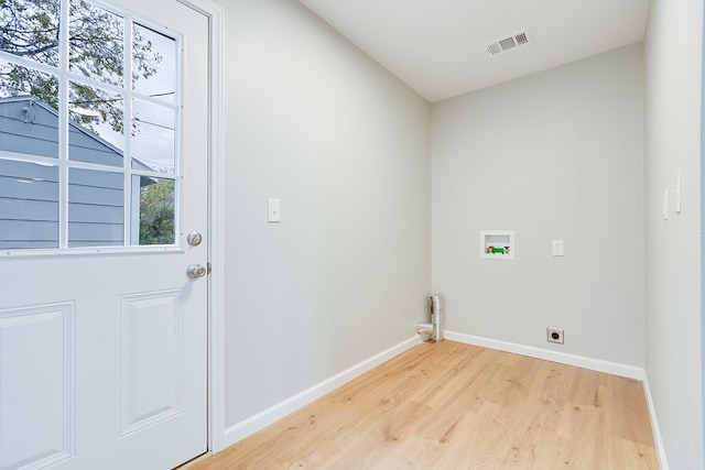 clothes washing area with washer hookup, electric dryer hookup, and light wood-type flooring