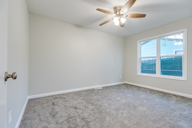 carpeted spare room featuring ceiling fan