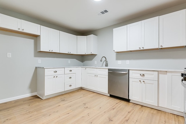 kitchen with white cabinets, sink, dishwasher, and light wood-type flooring