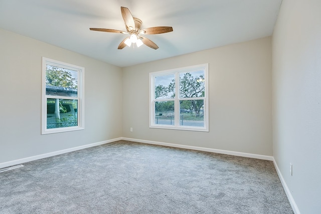 206 N Montague Ave, San Angelo, TX 76905 - carpeted spare room featuring a ceiling fan, baseboards, and a healthy amount of sunlight