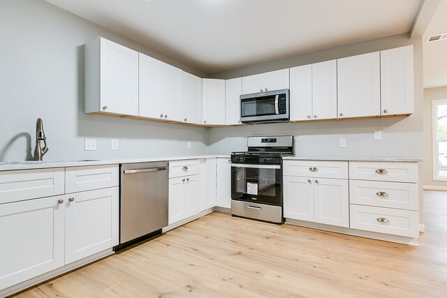 kitchen featuring white cabinetry, appliances with stainless steel finishes, and sink