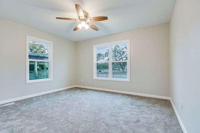 carpeted empty room featuring ceiling fan