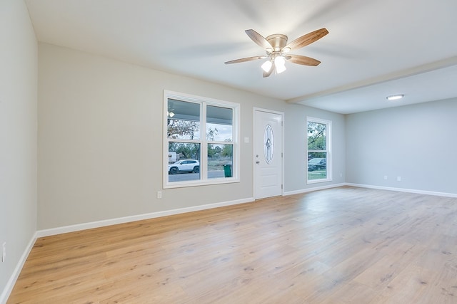 spare room with light hardwood / wood-style flooring and ceiling fan