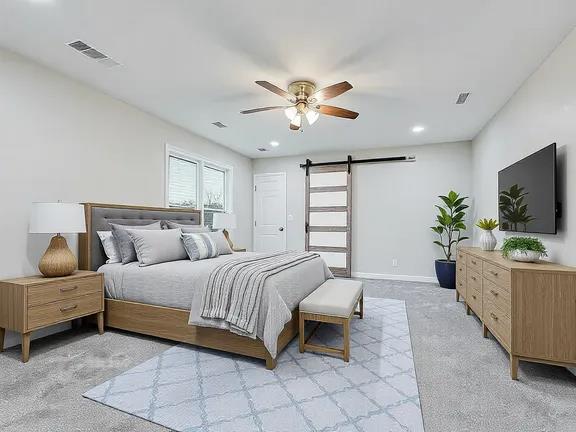 206 N Montague Ave, San Angelo, TX 76905 - bedroom with a barn door, visible vents, light colored carpet, and recessed lighting
