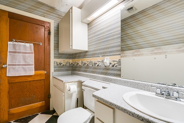 bathroom with toilet and vanity