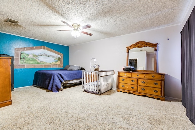 bedroom featuring visible vents, a textured ceiling, ornamental molding, and a ceiling fan