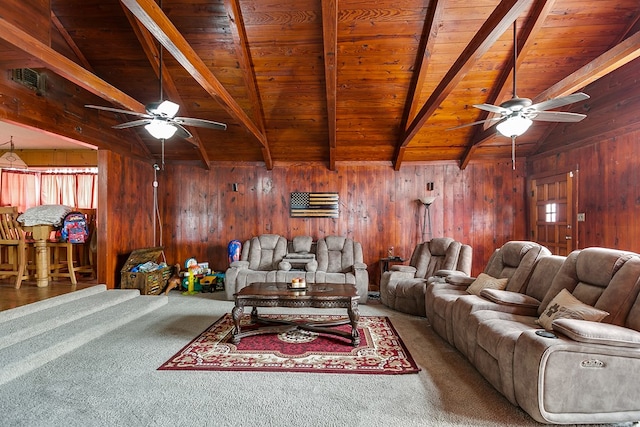 living room featuring carpet, vaulted ceiling with beams, a ceiling fan, and wood walls