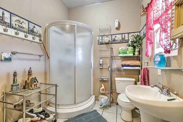 110 N Pope St, San Angelo, TX 76903 - bathroom featuring a stall shower, tile patterned floors, and a textured ceiling