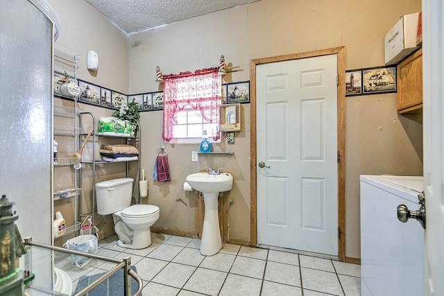 110 N Pope St, San Angelo, TX 76903 - bathroom with washer / dryer, tile patterned floors, and a textured ceiling