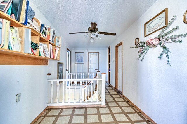 110 N Pope St, San Angelo, TX 76903 - hall with an upstairs landing, tile patterned floors, and a textured ceiling