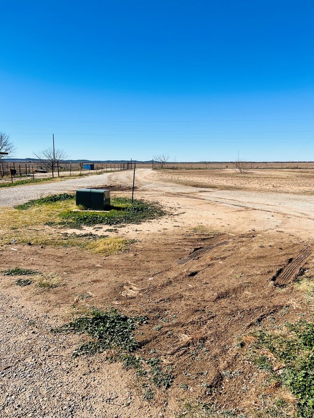 view of yard with a rural view and fence