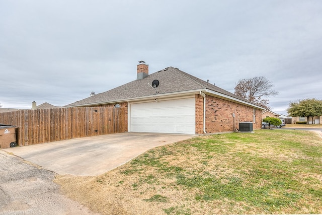 view of home's exterior featuring cooling unit, a garage, and a lawn